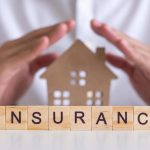 insurance-concept-hand-wooden-arrangement-on-wood-background-free-photo