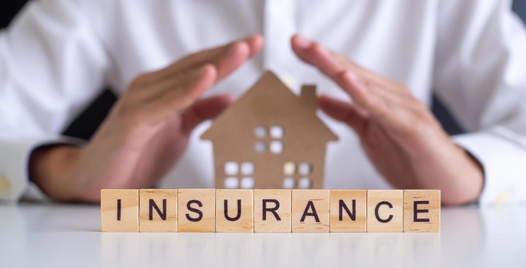 insurance-concept-hand-wooden-arrangement-on-wood-background-free-photo