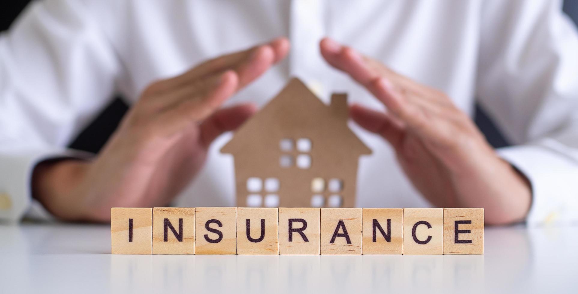 insurance-concept-hand-wooden-arrangement-on-wood-background-free-photo